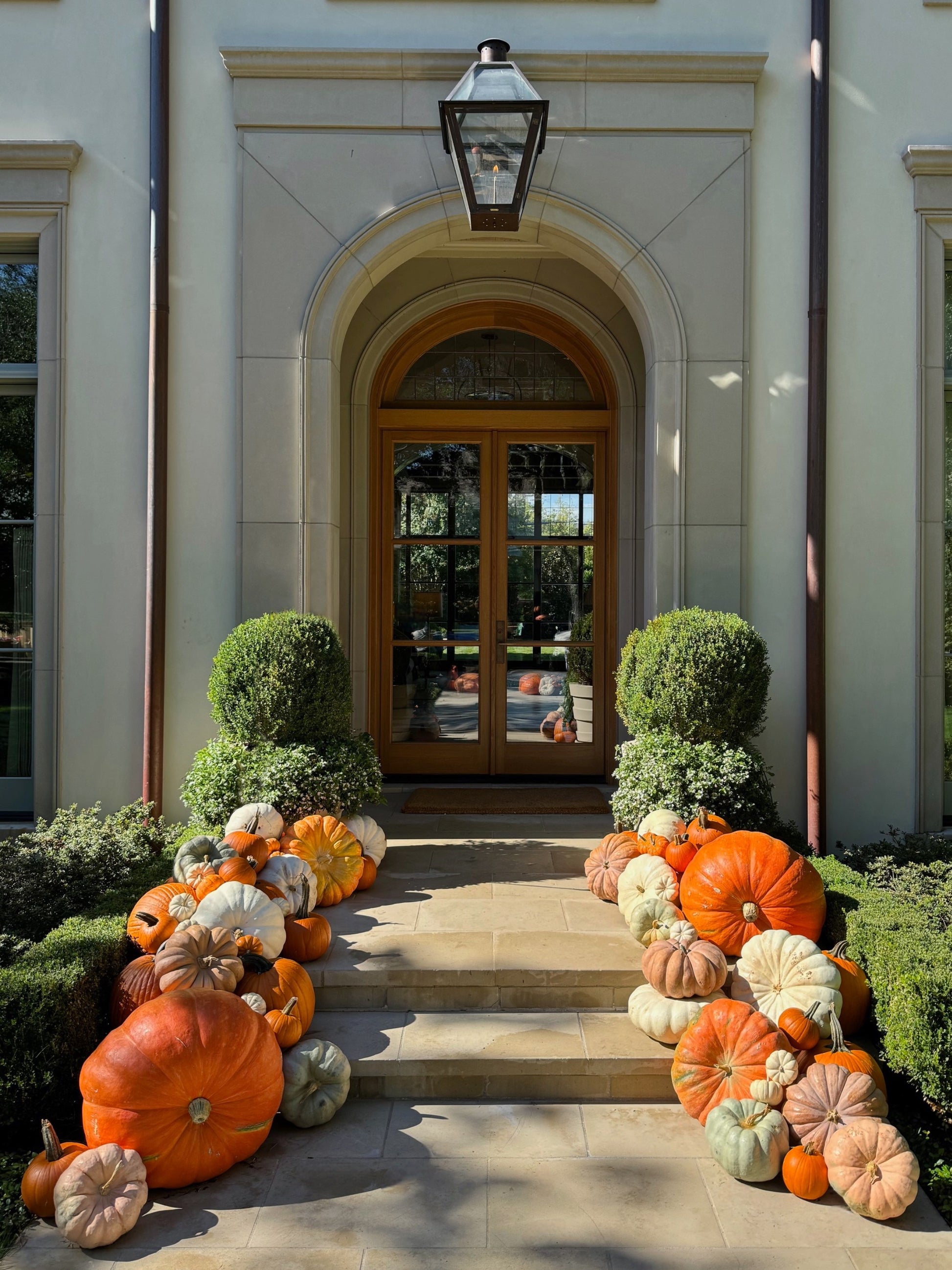 Decorative pumpkins arranged in front of a house entrance