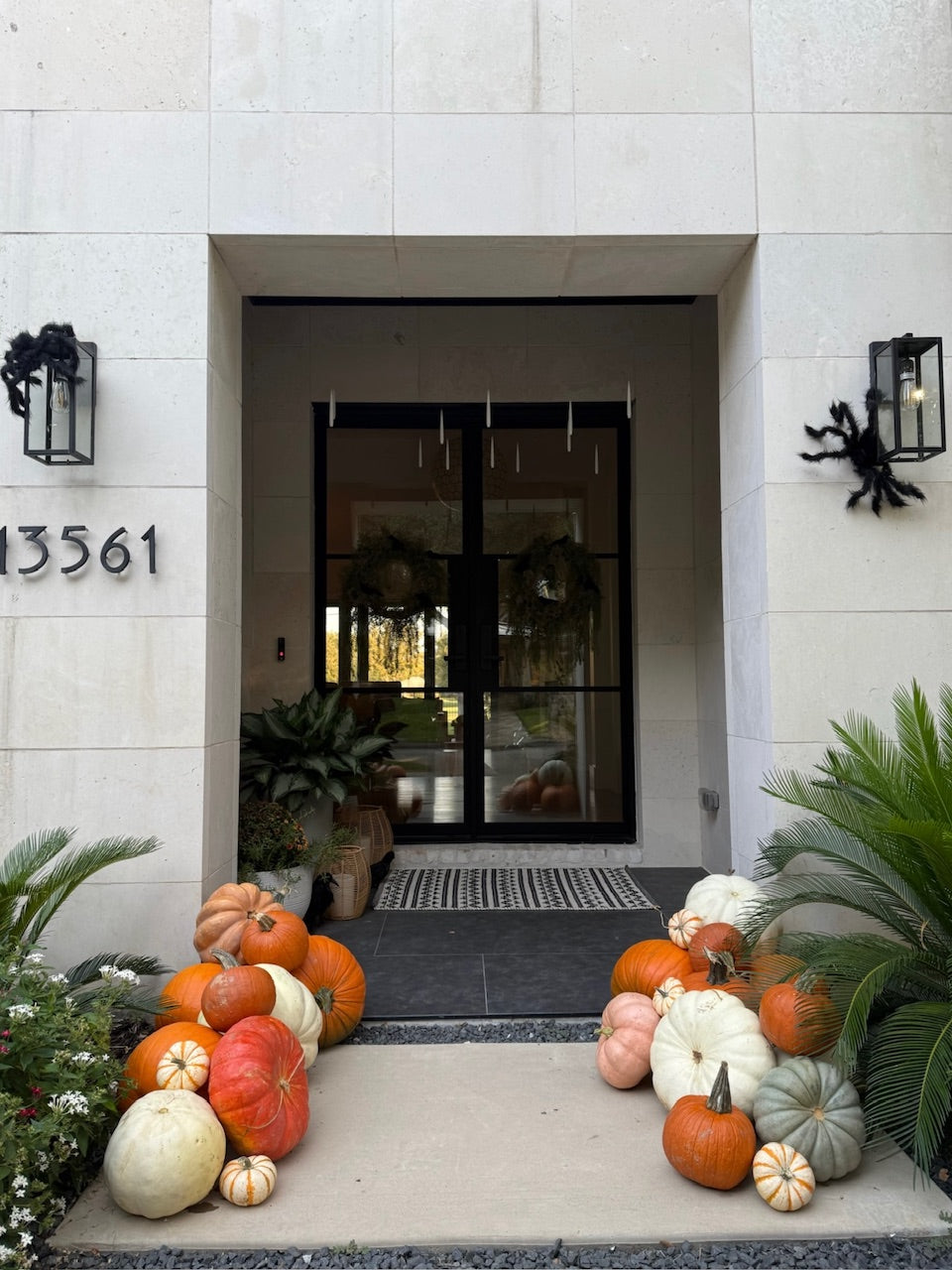 A variety of pumpkins decorate a modern porch. 