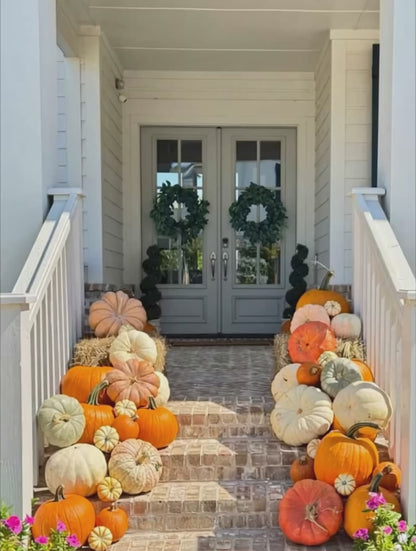 Video of brick porch steps decorated with an abundance of pumpkins. 