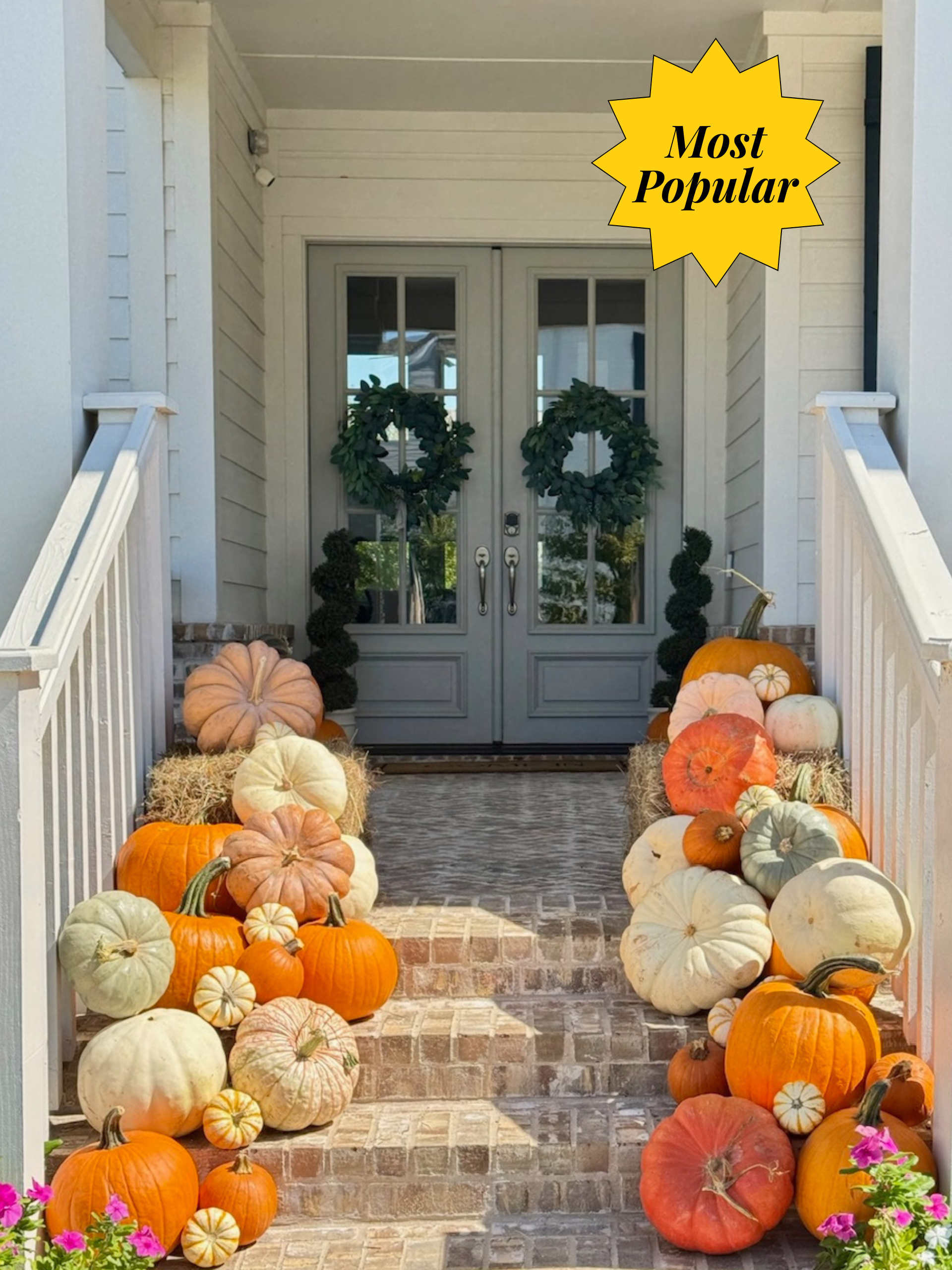 A variety of pumpkins of various sizes on a porch.